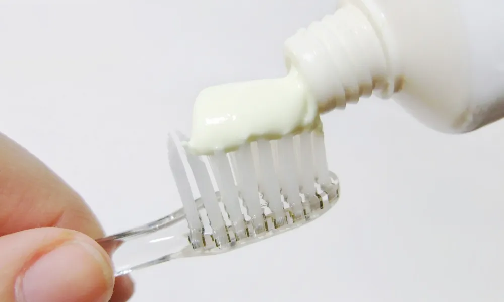 toothpaste being applied to toothbrush for daily oral care high point nc
