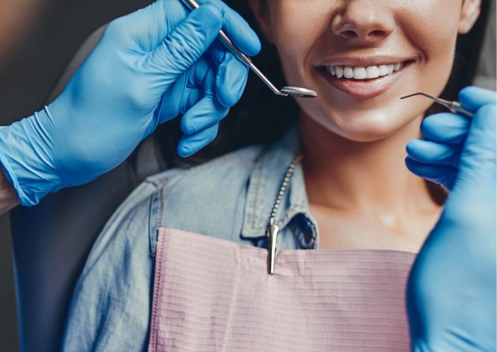 Patient showing a brighter smile during a dental visit, highlighting the effectiveness of teeth whitening strips for improving tooth color and appearance.