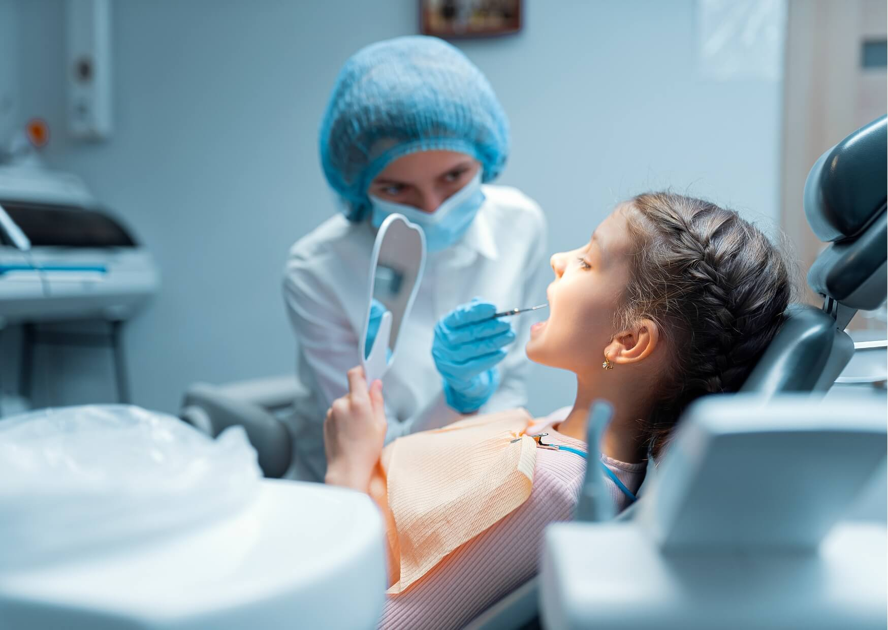Child having a pediatric dental exam to evaluate tooth spacing and determine whether a kids dental spacer may be needed after early tooth loss.
