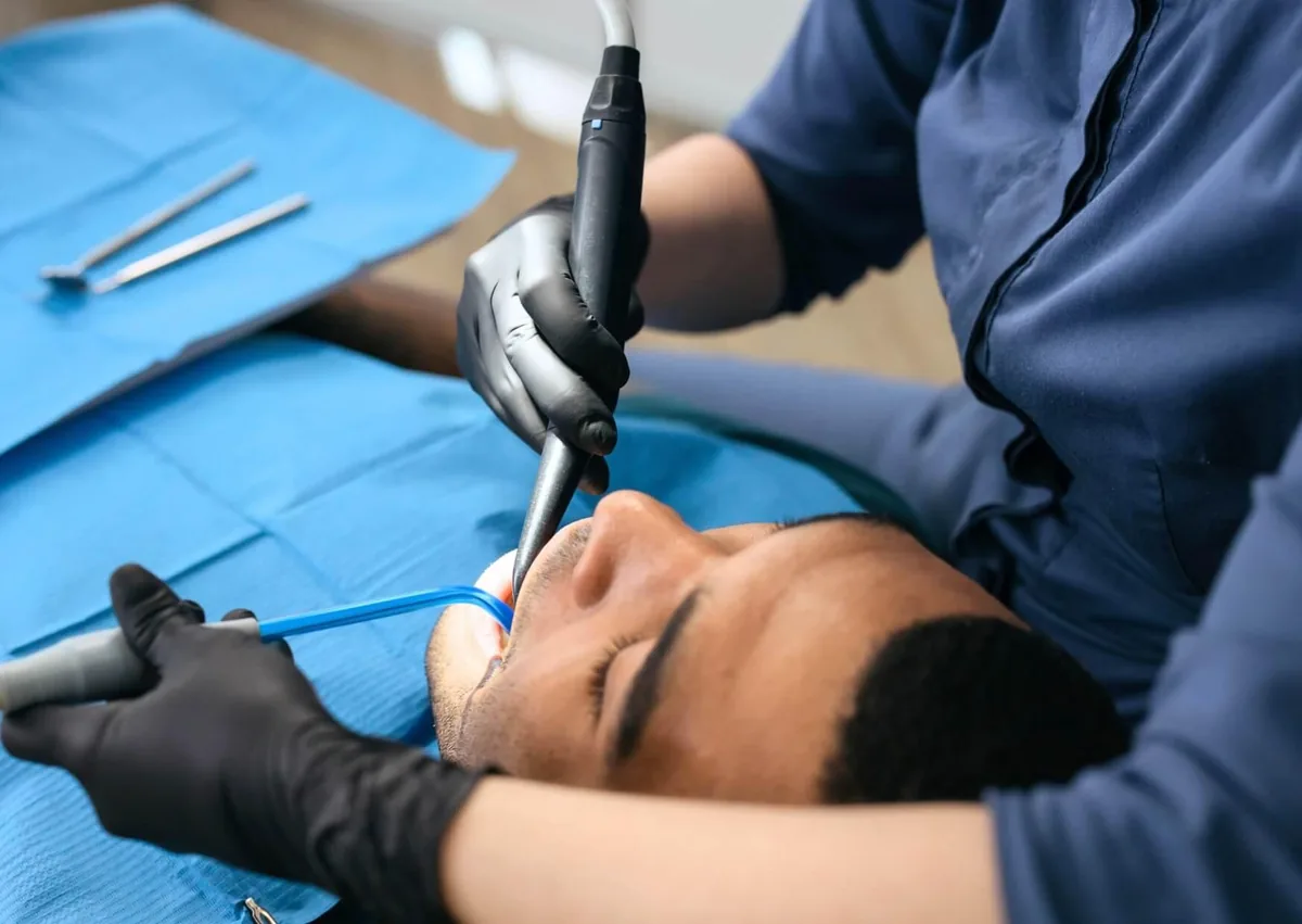 Dental professional treating a patient with a severe tooth infection.