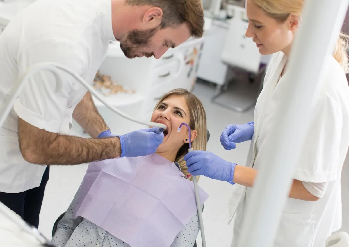 Dentist examining a patient experiencing wisdom tooth pain.