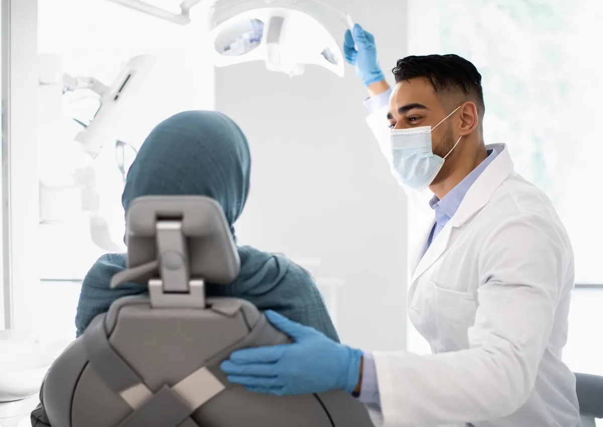 Dentist consulting with a patient about gum contouring treatment.
